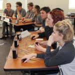 Members of teams from Norwich Free Academy, left, and Woodstock Academy, compete in an afternoon round.