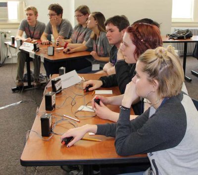 Members of teams from Norwich Free Academy, left, and Woodstock Academy, compete in an afternoon round.