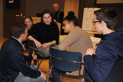 Members of the Glastonbury High team confer with their during a break in the final round of the Quahog Bowl.