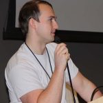 Joe Langan, a PhD student in biological oceanography at URI, talks to Quahog Bowl participants during a panel discussion.