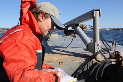 Kristin DeRosia-Banick records the time and date of the oyster sample collection.