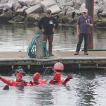 Trainees are taught to form a chain to swim towards the life raft.