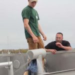 Trainer Steve Pigeon and fisherman Chad Davenport test how well the emergency repair worked to stop a leak.