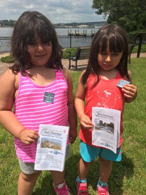 Fort Griswold Quest participants show off the stickers they earned for finding the treasure.