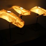 Three of the 'ghost whales' created by Kristian Brevik are mounted on lamp pedestals.