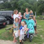 Rachel Aspinwall, rear left, and Catherine Newbury, rear center, collected trash while they walked at Bluff Point State Park on Aug. 1.