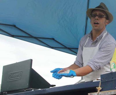 Chef Charlie Bailow shows a fillet he had just cut from a whole scup.