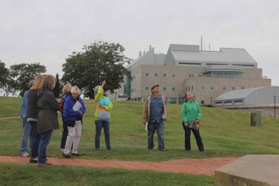 Judy Preston, center, tells members of the painters group the history of the Avery Point lighthouse.