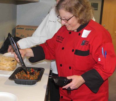 Jennifer Tessier, president of the Connecticut Chefs Association, samples a kelp and root vegetable salad made by Chef Ken Bergeron.