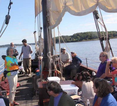 Long Island Sound Outreach Coordinator Judy Preston, left, talks about the numerous designations given in recognition of lower Connecticut River's unique ecological and cultural significance.
