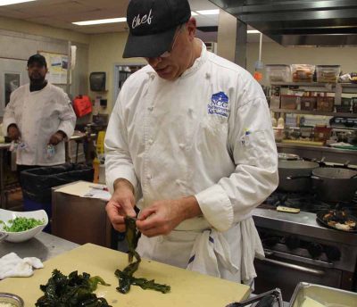 Chef Jeff Trombetta separates leaves of kelp before chopping.