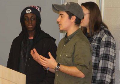 Liam Nagle, center, describes how hospitals, schools and other critical facilities in Miami Beach would be impacted for a four-foot rise in sea level as team members Florence Opoku, left, and Sara Schechter, await their turn for their portions of the presentation.