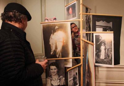 Attendees at the opening of "Crosscurrents" learn about women who went to sea in "A Further Sea" and "Seafaring Women" exhibits created by Anastasiia Raina and Rebecca Sittler.