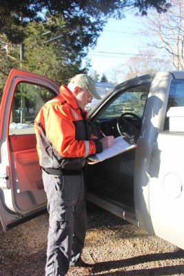 Murphy logs the time and date of a water collection before heading to the next sampling site.