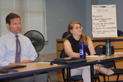 Bryan P. Hurlburt and Lauren Gauthier, special projects manager at Copps Island/Norm Bloom & Son Oysters, listen to comments during the meeting.
