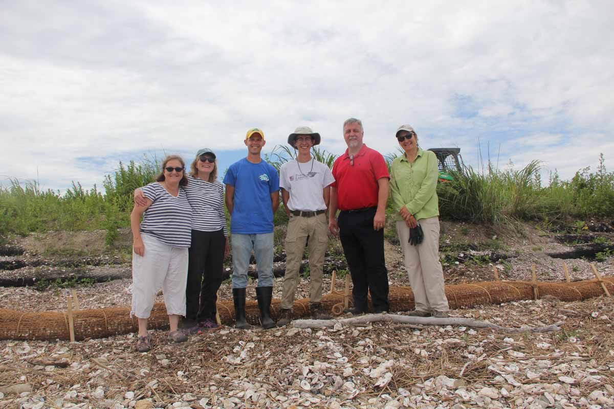 First, second and fifth from left, Syma Ebbin, Nancy Balcom, and Sylvain De Guise, research coordinator, associate director, and director, respectively, of Connecticut Sea Grant, gather at the site with Chris Hauser, third from left, associate director of Delaware Sea Grant, University of Delaware student Sam Koeck, fourth from left, and Sacred Heart University Prof. Jennifer Mattei, far right.