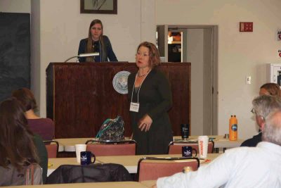 Kristin DerRosia-Banick, environmental analyst at the state Bureau of Aquaculture, answers a question after the talk by Emily Van Gulick, at podium, about harmful algal blooms.