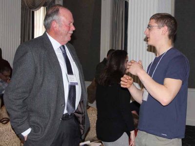 UConn Professor Charles Yarish, left, talks to a symposium participant after his keynote presentation.