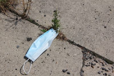 Discarded face masks and other personal protective equipment are ending up on sidewalks and other outdoor spaces.