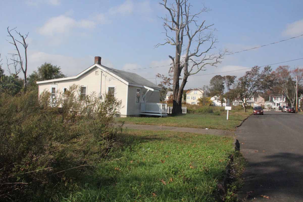 This house and more than two dozen others in the Old Field Creed neighborhood are slated for purchase and demolition in future phases of the project. The houses sits between now-empty lots where other homes stood until they were purchased and razed by the USDA-NRCS project.