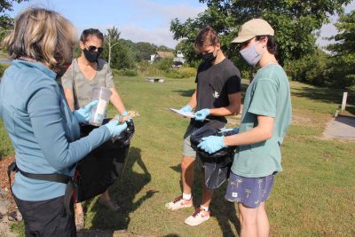 David Camperchiolli of Westbrook tallies a plastic cup and a food wrapper collected by another volunteer during the cleanup.