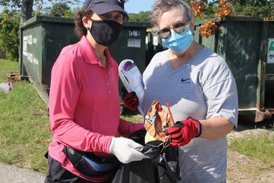 Kerry Morth of Waterford, right, deposits a Doritos wrapper, plastic straw and other items in the bag held by Barbara O'Neill of New London.