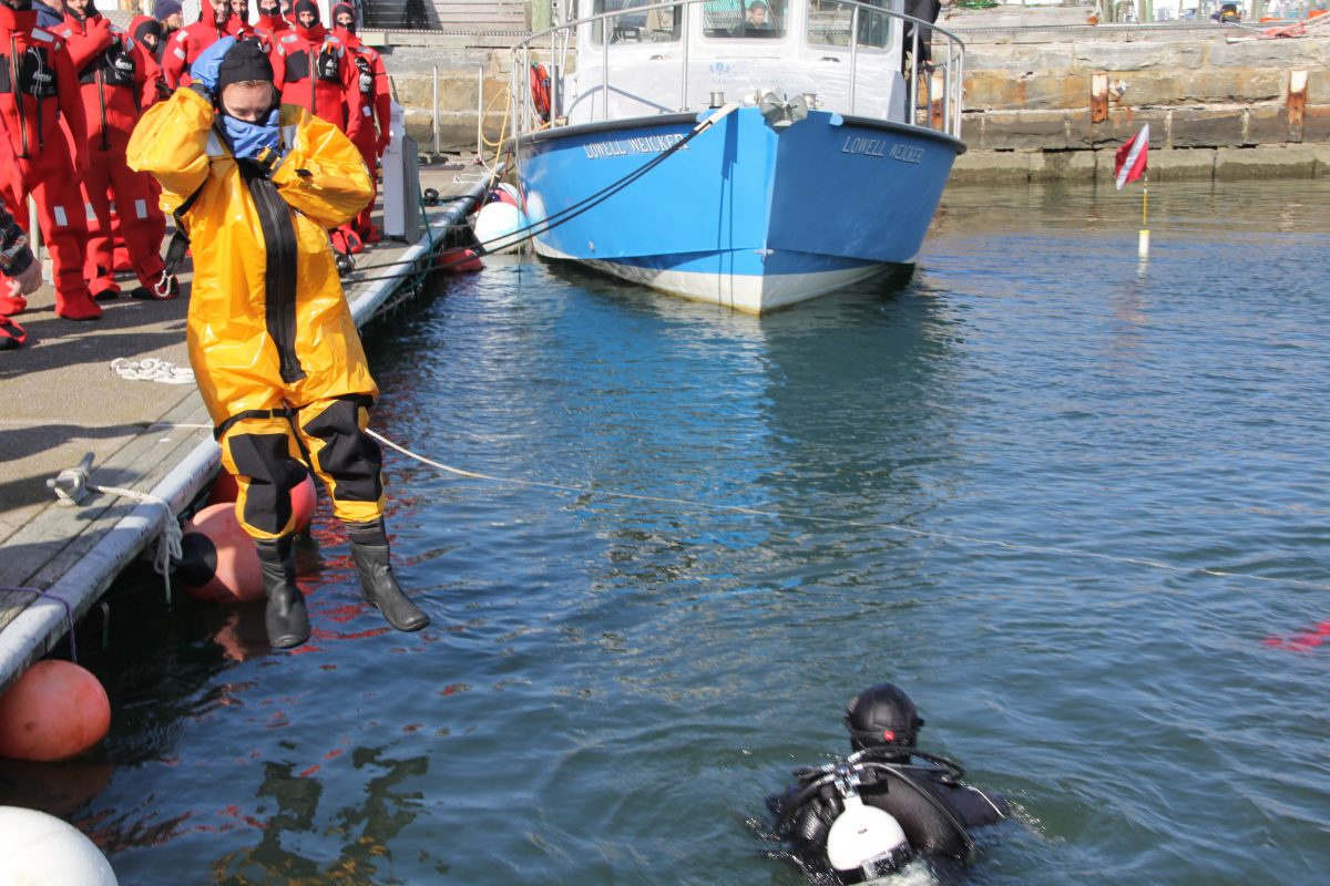 Another trainee jumps in to practice in her immersion suit.