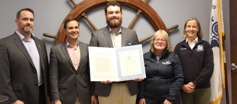 Fisherman John Genther, center, received a Meritorious Service Award from the Coast Guard for saving a man's life less than two weeks after taking first aid training hosted by CTSG.