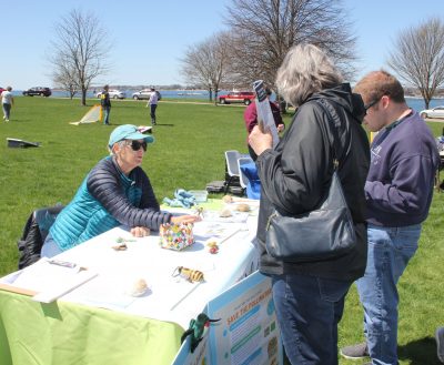 Kristin Distante, left, tells members of the public about the importance of pollinators in our local environment.