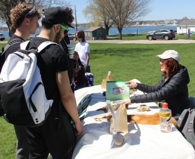 UConn students learn about local birds and mammals at the Denison Pequotsepos Nature Center table at the event.