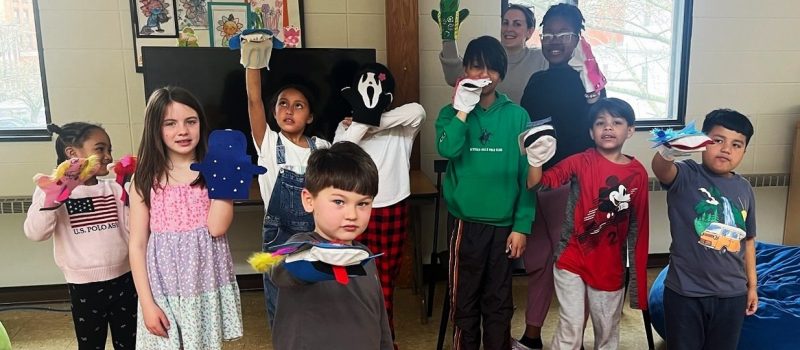 Students at the Drop-In Learning Center in New London show the sea creature puppets they made with CTSG's Maggie Cozens and Judy Benson on April 15.